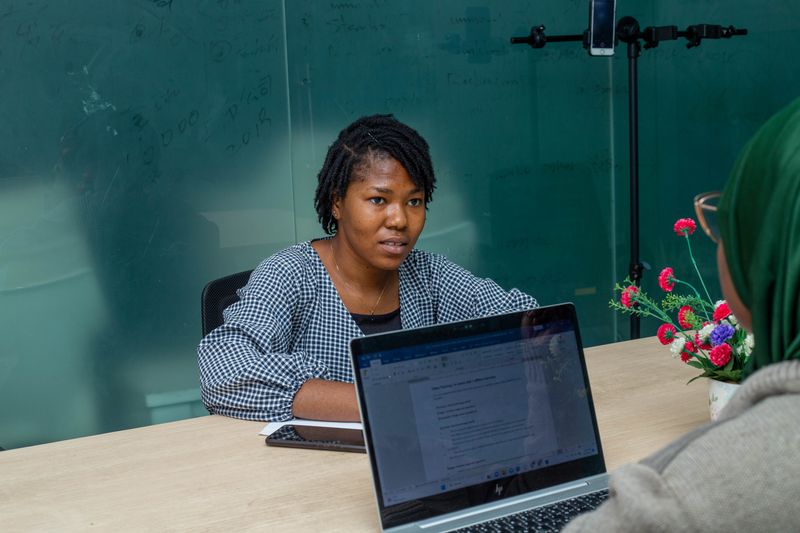 African colleagues collaborating around laptops in a Lagos office